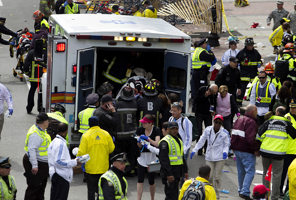 Echipaje de prim ajutor urcă răniţi într-o ambulanţă, după ce două explozii au avut loc aproape de linia de sosire a celui de-al 117-lea Maraton Boston, luni, 15 aprilie 2013. 