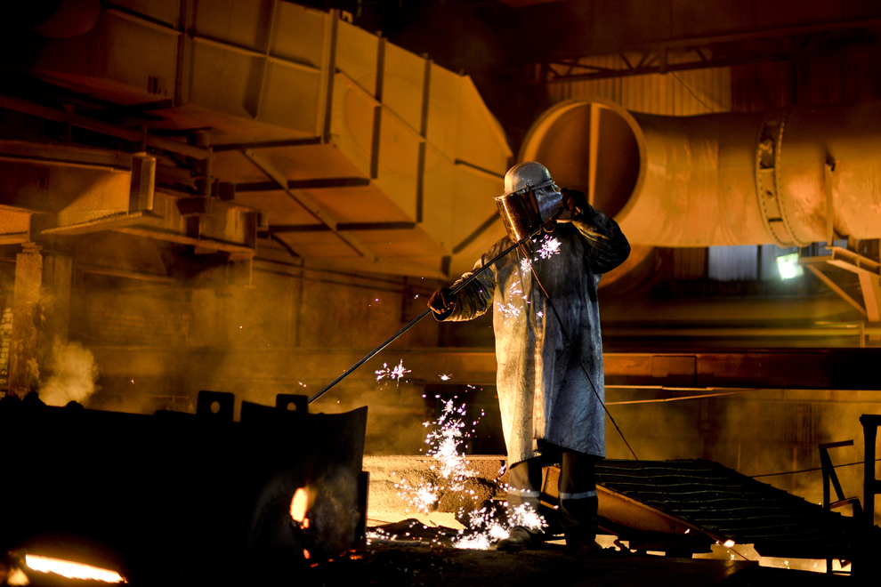 Un angajat al ArcelorMittal monitorizează fluxul de minereu topit în interiorul furnalului numarul 5 al combinatului ArcelorMittal din Galaţi, joi, 16 ianuarie 2014.