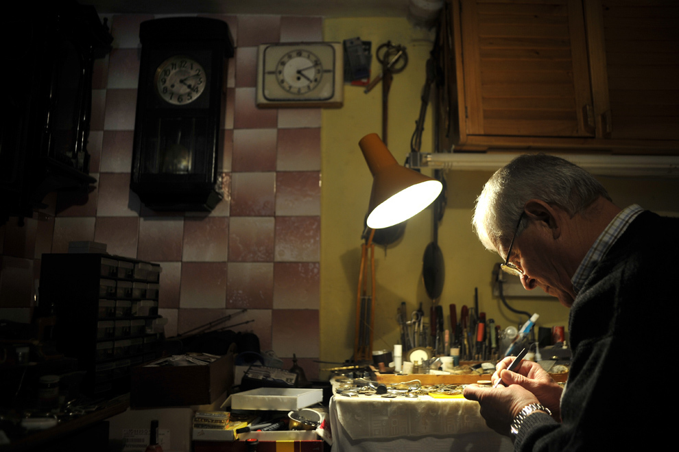 Aurel Mureşan repară un ceas, în Cluj, marţi, 11 februarie 2014. Aurel Mureşan, pensionar clujean, are o colecţie de peste 2.500 de ceasuri, pe care le-a adunat în decurs de 25 de ani.
