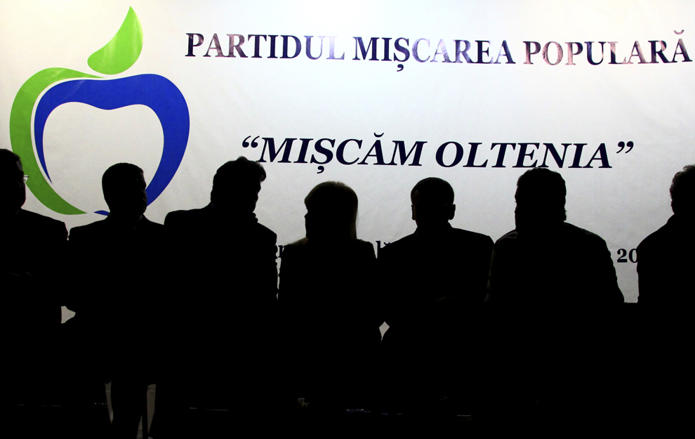 Siluete ale membrilor Partidului Mişcarea Populară (PMP) pot fi văzute în timpul proiecţiei unui film, la întâlnirea regională a PMP, sâmbătă, 22 februarie 2014, la Craiova.