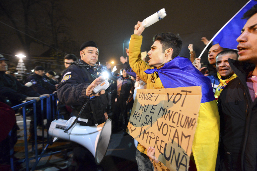 Persoane manifestează în zona blocajului realizat de jandarmerie în apropierea sediului PSD, după aflarea rezultatelor exit-pollurilor la alegerile prezidenţiale, pe Soseaua Kiseleff din Bucureşti, duminică, 16 noiembrie 2014.