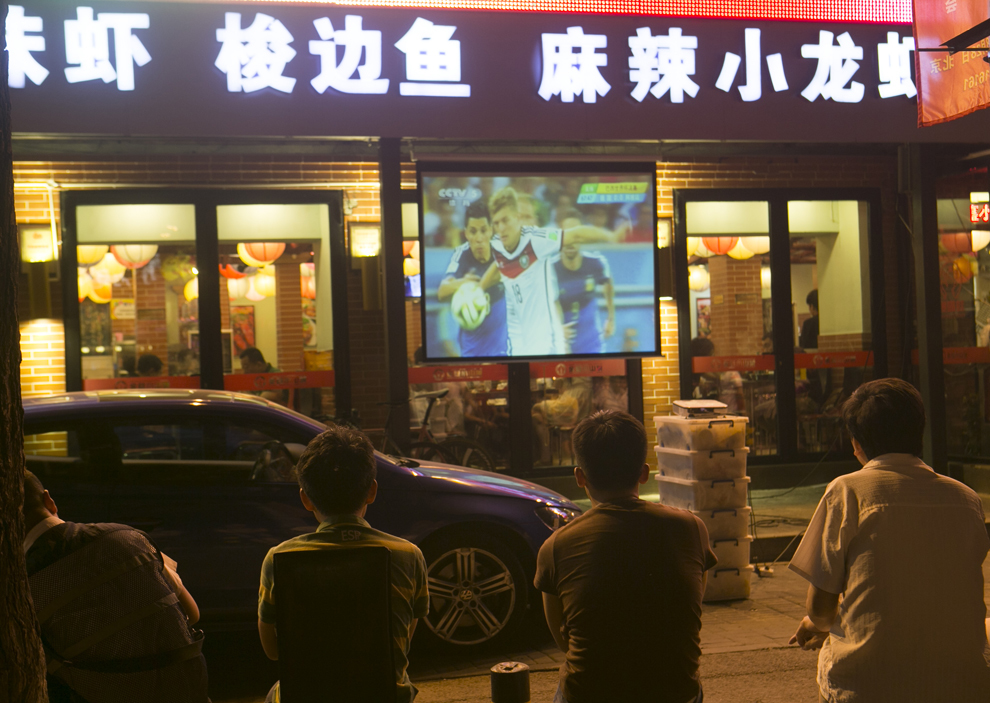 Fani chinezi urmăresc o transmisiune în direct din timpul finalei Cupei Mondiale la fotbal FIFA 2014, dintre Germania şi Argentina, în Beijing, China, luni, 14 iulie 2014.