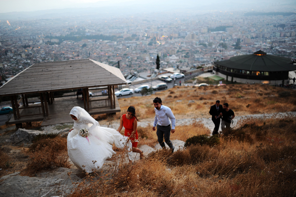 Un cuplu proaspăt căsătorit urcă un deal de lângă oraşul Antalya, Turcia, joi, 29 august 2013.  