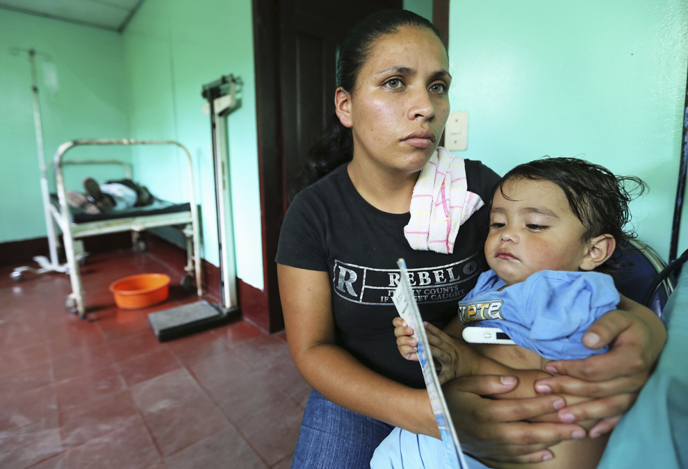 O femeie îşi tine în braţe copilul afectat de febră dengue, într-un spital din Managua, Nicaragua, miercuri, 24 iulie 2013.