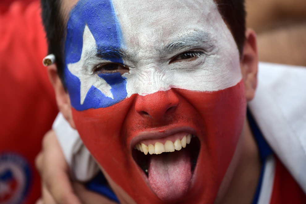 Un suporter chilian îşi incurajează echipa înaintea meciului dintre Spania si Chile din grupa B a Campionatului Mondial de Fotbal, stadionul Maracana din Rio de Janeiro, 18 iunie 2014.