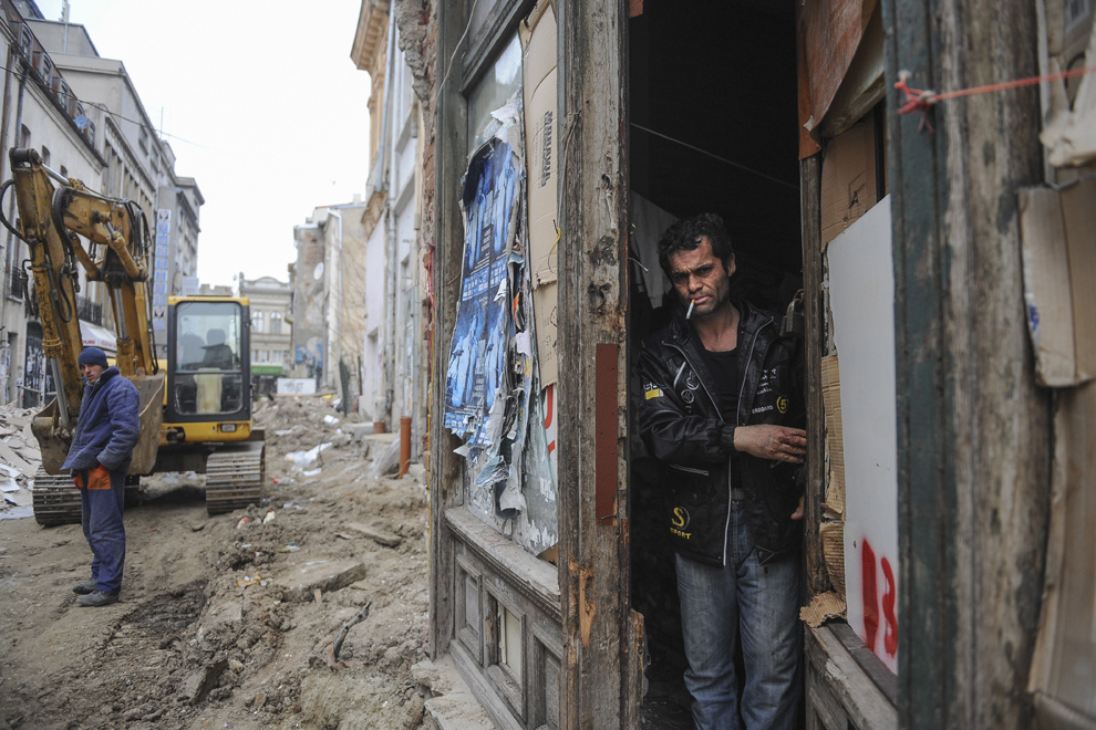 Un bărbat deschide uşa casei în care stă ilegal alături de familia lui, pe strada Gabroveni, aflată în reabilitare, în Centrul Vechi din Bucureşti, duminică, 27 februarie 2011.