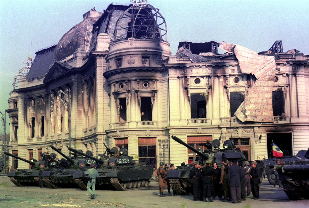 Blindate ale armatei române staţionează în Piaţa Palatului (actuala Piaţa Revoluţiei), în faţa fostului sediu al Comitetului Central al Partidului Comunist Român, în Bucureşti, în timpul evenimentelor din decembrie 1989.